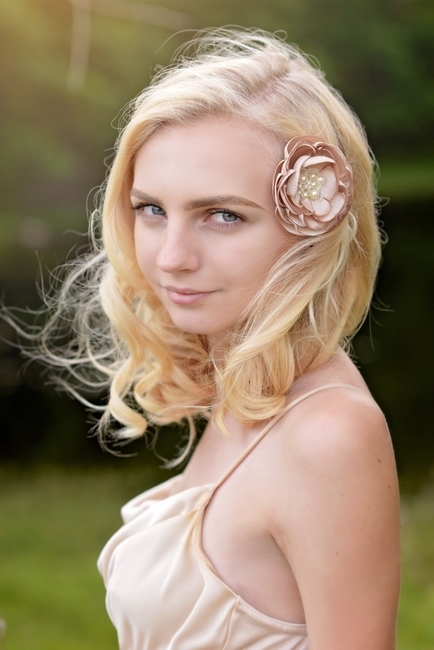 Blonde female wearing a champage-colored and pearl hair flower