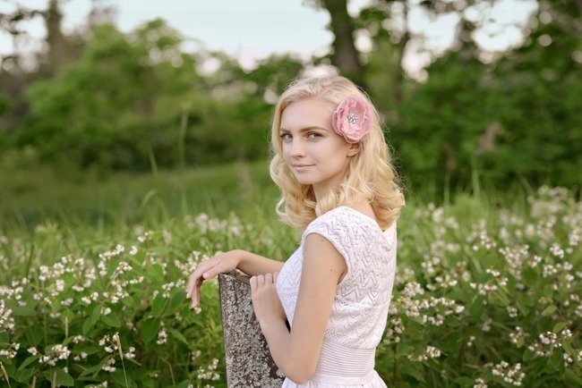 Female in meadow wearing pink hair flower